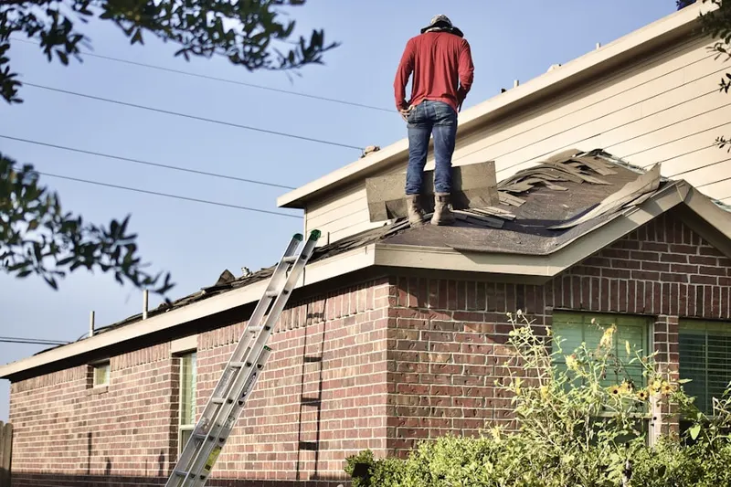Professional roofer working on a residential roof in Saltsburg
